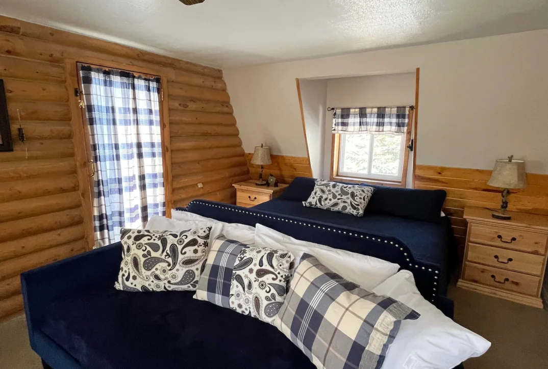 A blue bed in a cabin room